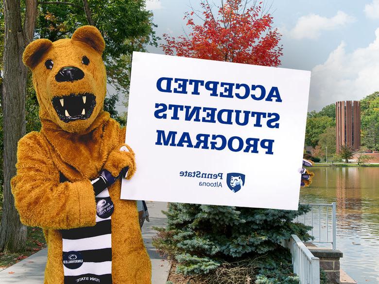 The Nittany Lion mascot holding a sign advertising the college's Accepted Students Program